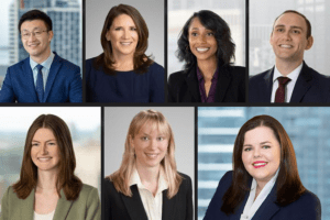 Seven different headshots of men and women of various races. All are wearing suits and the images are separated by thin gray lines