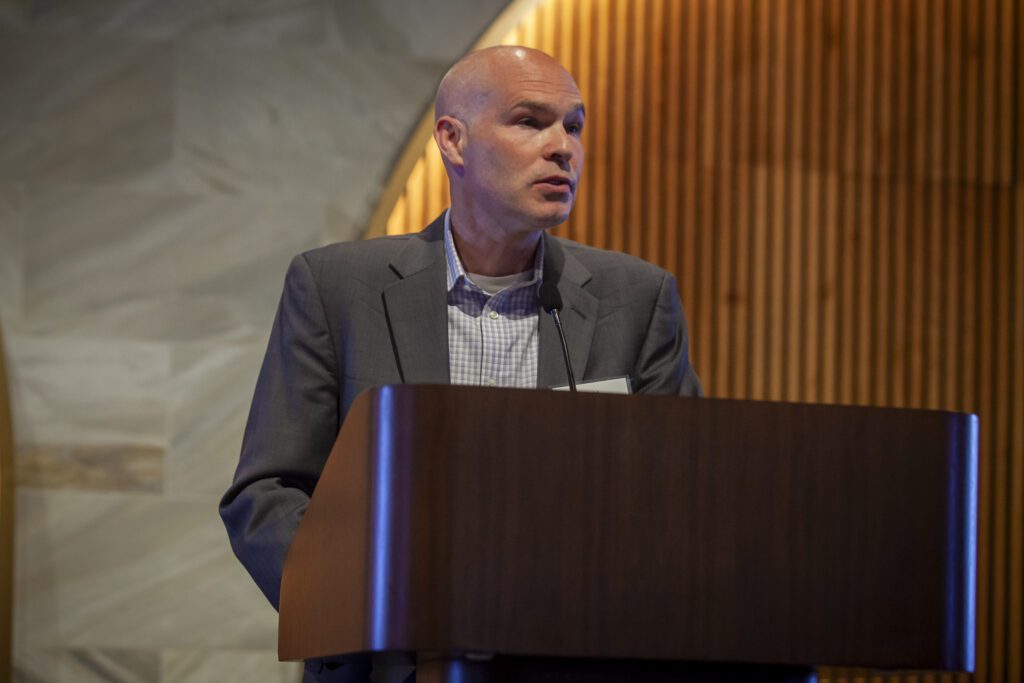 A man stands at a podium talking